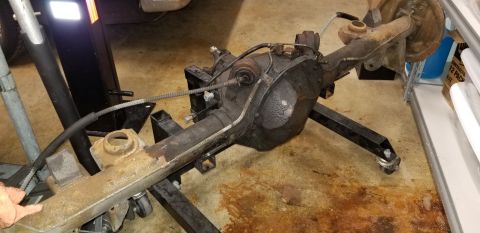 1970 Pontiac GTO — Rear axle assembly on a wheeled stand, showing brake drums and suspension components.