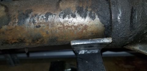 1970 Pontiac GTO — Stamped text KDC 083 2 on a rusty metal axle housing.