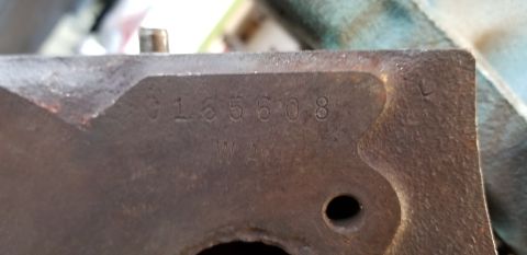 1970 Pontiac GTO — Close-up of engine part with numbers 0165608, WA, and L stamped.