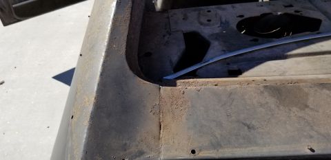 1970 Pontiac GTO - This close-up shot shows the rusted interior of a vehicle's body panel, possibly a trunk or wheel well area. The metal is heavily corroded…