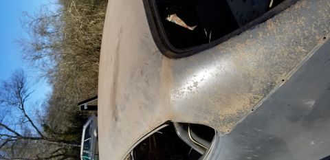 1970 Pontiac GTO - The image shows a close-up view of the rusty, weathered roof and upper body panel of a classic car, possibly a 1970 Pontiac GTO, against a…