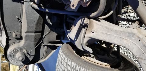 1970 Pontiac GTO - This is a close-up, low-angle view of the undercarriage of a vehicle, focusing on the suspension components and a tire. The scene appears t…