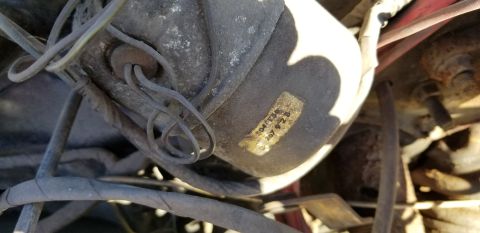 1970 Pontiac GTO - A close-up view shows a label with text "04/T3S 267 9 2 B" on a dusty, gray, cylindrical automotive part. Wires are connected to the part a…