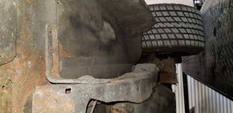 1970 Pontiac GTO - The underside of a vehicle shows significant rust on the frame and body panels. A tire is visible in the upper right portion of the image.