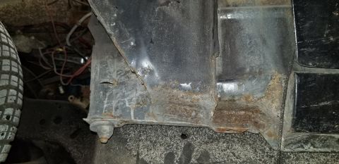 1970 Pontiac GTO - This image shows the heavily rusted and corroded frame and body mounts of a vehicle, likely from the undercarriage. Wires and a portion of…