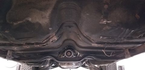 1970 Pontiac GTO - Underside view of a vehicle chassis, showing the transmission tunnel and exhaust components. The frame appears to be made of metal with som…