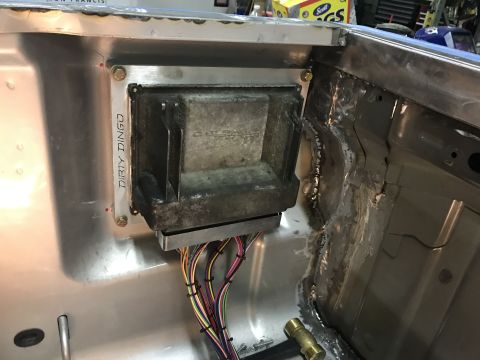 1995 Chevrolet C/K Pickup - A close-up view shows a vehicle's wiring harness connected to a control module, with "DIRTY DINGO" visible on a bracket.