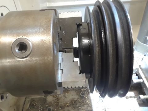 1985 Ford Bronco - Pulley attached to a lathe chuck, likely for engine repair or machining.