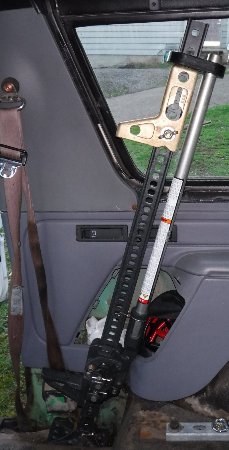 Decided on a mounting location for the Hi-Lift jack, just need to fabricate a bracket to hold it a safe distance from the glass.  The base will be strapped to the bolt below the seat belt reel.