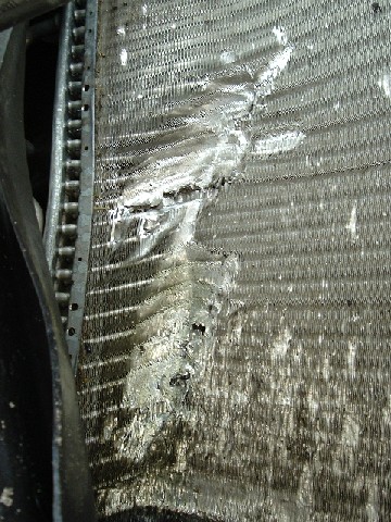 1999 Ford Crown Victoria - a/c condensor. Apparently, when my roommate went through the fence, a board came up from underneath and did this.