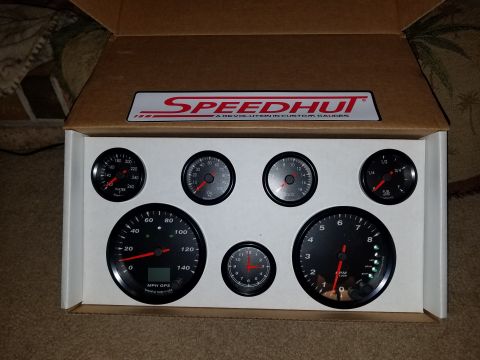 1977 Ford Ranchero - A set of Speedhut gauges, including a speedometer and tachometer, are displayed in their packaging.
