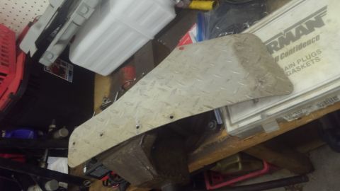 1996 Ford Bronco - A diamond plate metal part is shown on a workbench, with various other items in the background.