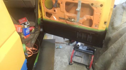1996 Ford Bronco - Interior of a vehicle door is exposed, with various repair supplies scattered around the floor.