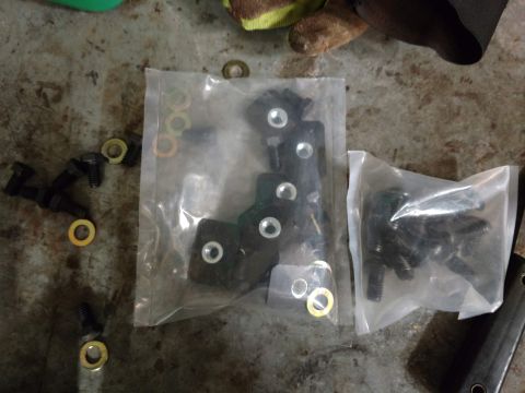2018 Toyota 4Runner - Hardware kit with bolts and washers is packaged in plastic bags on a workbench.