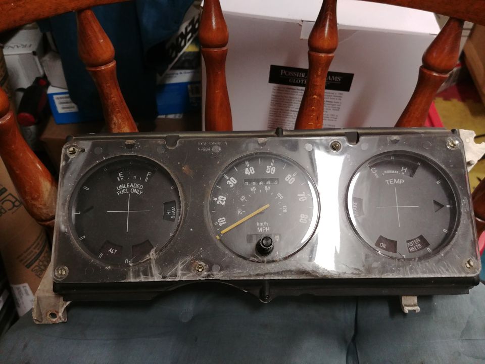 Dashboard instrument cluster with fuel, speed, and temperature gauges. Some text is visible