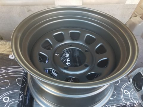 1993 Ford Bronco - Close-up of a dark gray aftermarket wheel with a 'driven' logo on the center cap.
