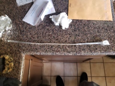 1993 Ford Bronco - A metal rod, likely a part, is laid out on a kitchen counter next to mail and other items.