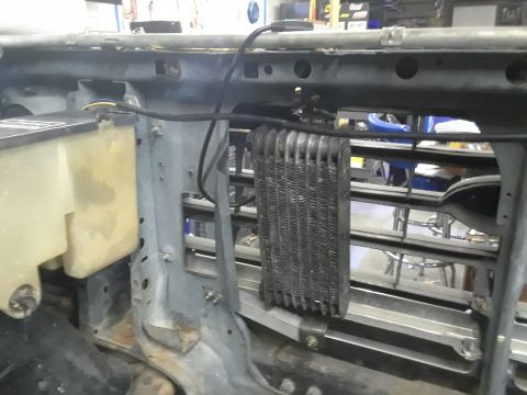 1985 Ford Bronco - Close-up view of engine bay components, including a transmission cooler and coolant reservoir.