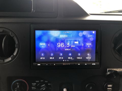 2010 Ford E250 - Interior view of a vehicle's dashboard, focusing on the infotainment system and climate controls.