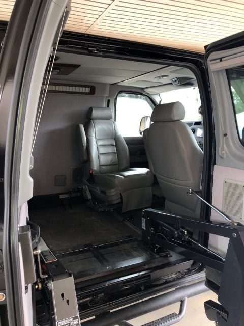 2010 Ford E250 - This van's interior features leather seats and a lift system for accessibility.