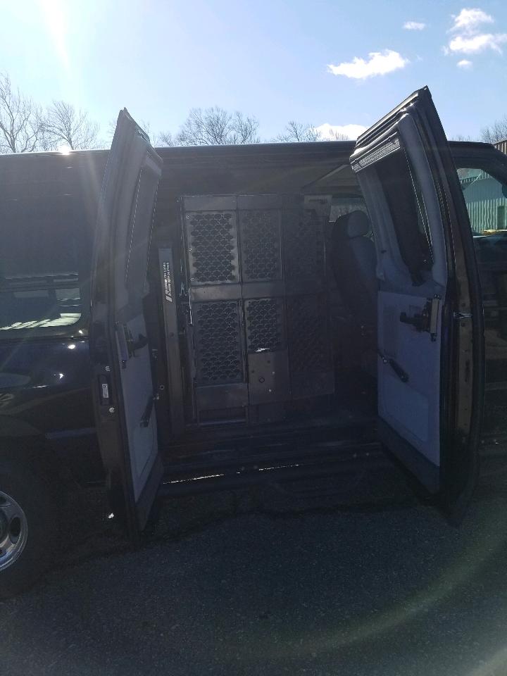 2010 Ford E250 van interior showing cargo partitions and open side doors
