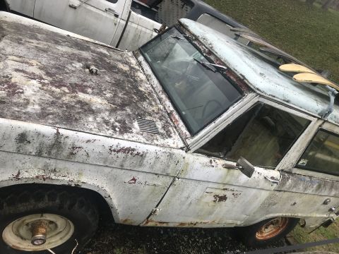 1967 Ford Bronco - This weathered vehicle appears to be an older SUV, possibly a Ford Bronco, in a state of disrepair.