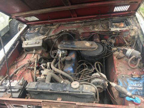 1967 Ford Bronco - The engine bay of a 1967 Ford Bronco shows its original FoMoCo battery and engine components.