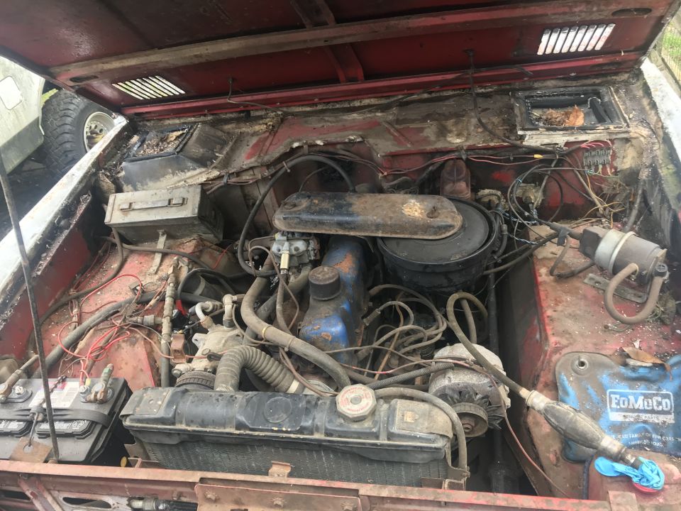 1967 Ford Bronco engine bay with FoMoCo battery