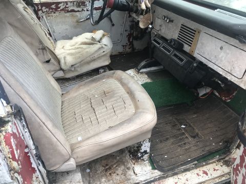 1967 Ford Bronco - The interior of a 1967 Ford Bronco shows significant wear on the seats and dashboard.