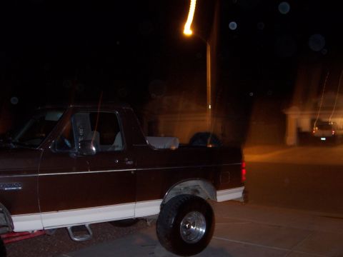 1992 Ford Bronco - Side profile of a 1992 Ford Bronco captured after dark.