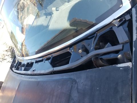 1993 Ford Bronco - Close-up of the windshield wiper cowl area on a 1993 Ford Bronco, showing exposed components.