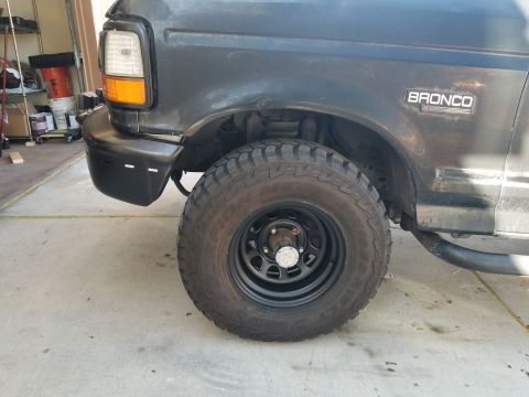 1993 Ford Bronco - Front passenger side view of a dark gray 1993 Ford Bronco, showing the wheel and fender.