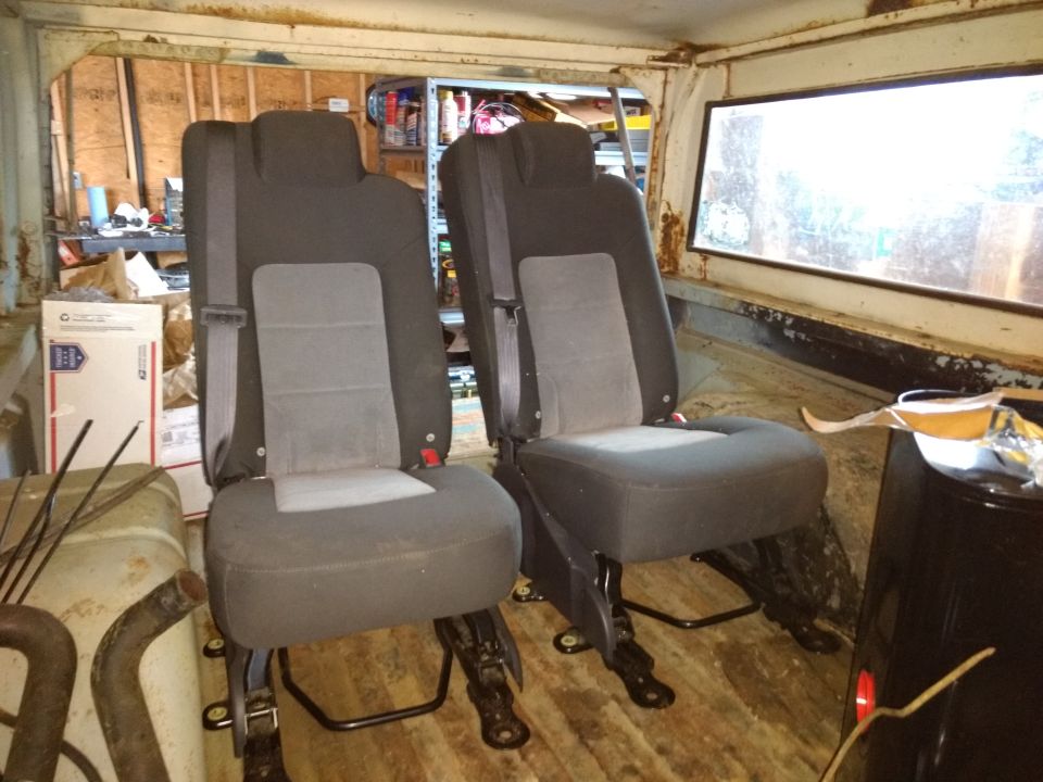 Identical second row center seats from two different 04-ish Expeditions.  Paid $35 out the gate at Pick-n-Pull for the pair.  Not the sexiest things but the integrated shoulder belts are helpful and they fold flat when the boys aren't with me.