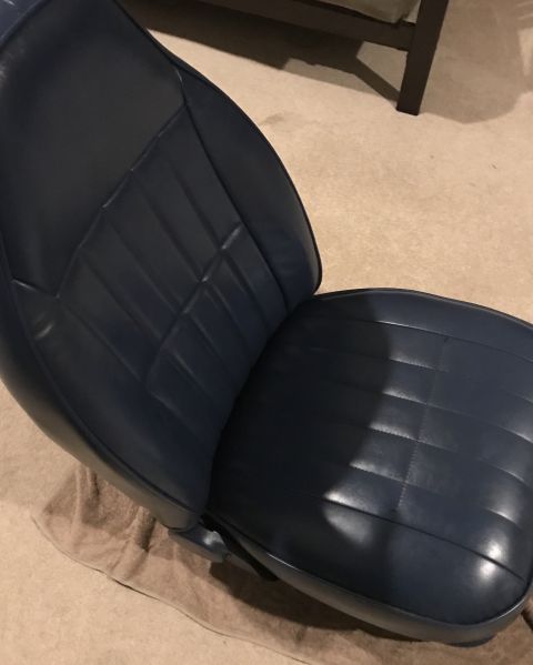 1995 Ford Bronco - A blue vinyl car seat with diamond stitching is shown indoors.