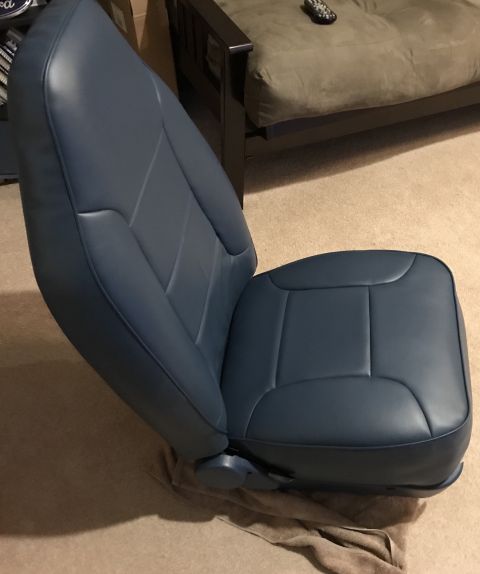 1995 Ford Bronco - A single car seat is displayed indoors, resting on a cloth.