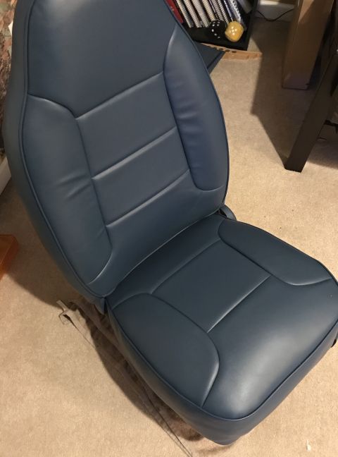 1995 Ford Bronco - A blue car seat is shown from a side angle, with a watermark at the bottom right.