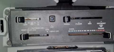 1988 Ford Bronco - The climate control panel features multiple sliders and labels for adjusting the vehicle's interior temperature and airflow settings.