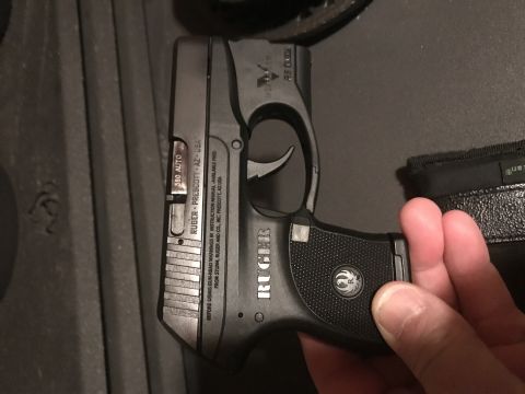 1993 Ford Bronco - A Ruger pistol is held in hand, with visible text indicating it is a .380 AUTO model made in Prescott, AZ.