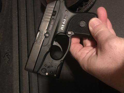 1993 Ford Bronco - Ruger LCP pistol with serial number 373-02189 is held by a hand.
