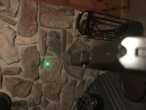 1993 Ford Bronco - A green laser dot is visible on a stone wall next to a fireplace tool set.