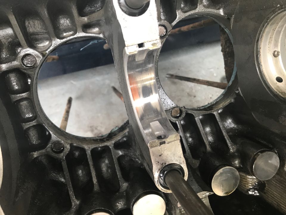 Close-up of an engine block showing a crankshaft bearing and cylinder bore