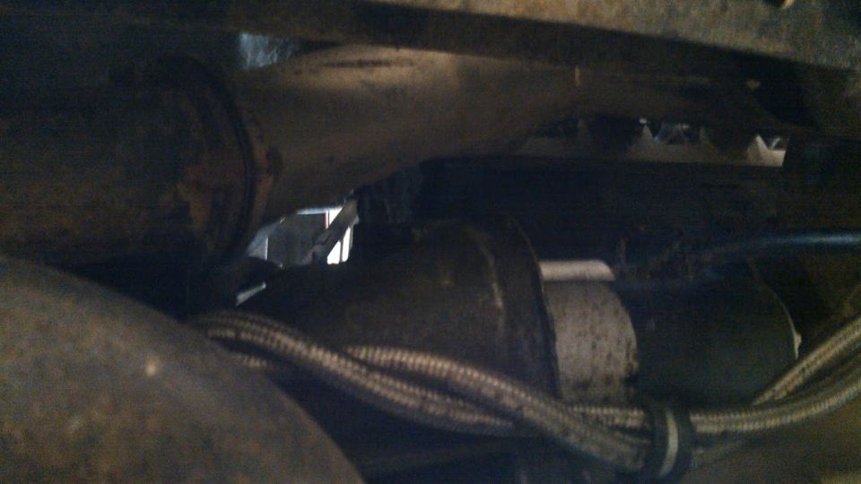 vehicle starter motor and exhaust pipe detail