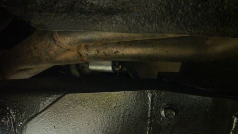 1978 Ford Bronco - Close-up shot of the vehicle's undercarriage, focusing on the exhaust system and frame components.