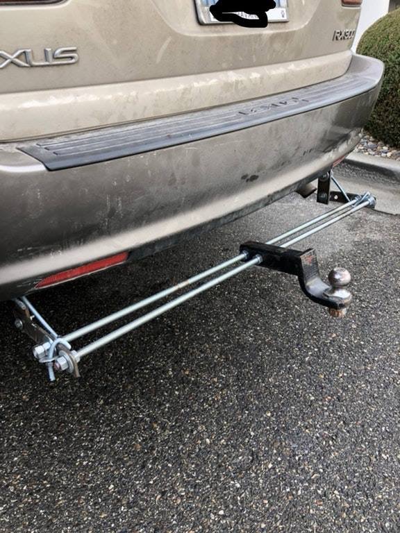 Tan SUV rear bumper with a trailer hitch attached