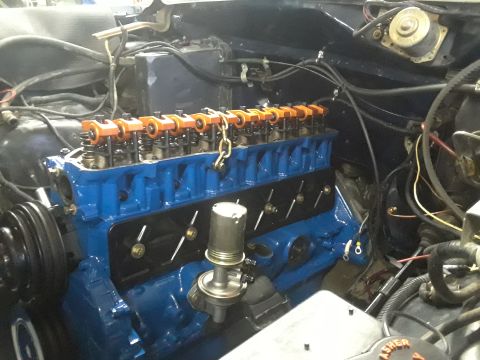 1985 Ford Bronco - Close-up view of a rebuilt engine, showing the blue block and orange valve covers.