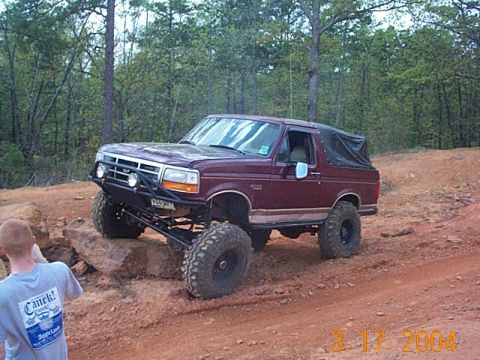 1986 Ford Bronco - This lifted Ford Bronco navigates a challenging off-road course, its off-road capabilities.