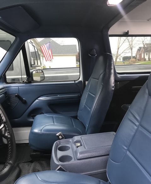1995 Ford Bronco - Interior view of a 1995 Ford Bronco, showing the blue seats and dashboard.