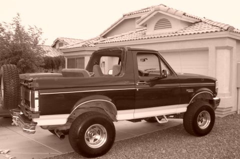 1992 Ford Bronco - This 1992 Ford Bronco is parked in front of a house with a garage.