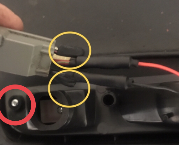 Close-up of electrical connectors and wiring with red and yellow circles highlighting components