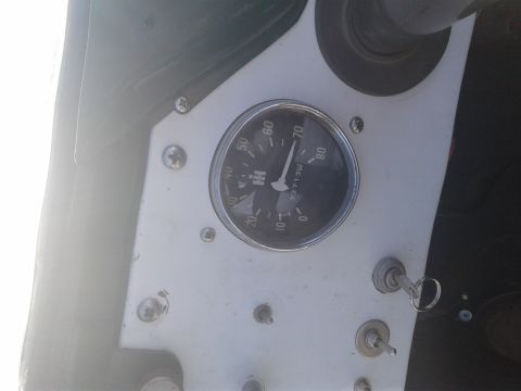 1991 Ford Bronco - Close-up of an interior gauge cluster an International Harvester logo and a key in the ignition switch.